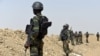 FILE - Cameroonian soldiers patrol in the Cameroonian town of Fotokol, on the border with Nigeria, after clashes between Cameroonian troops and Nigeria-based Boko Haram insurgents, Feb. 17, 2015.