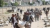 Relatives carry bodies of the victims of air strikes on a detention center to be buried at a cemetery in Saada, Yemen January 25, 2022.