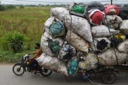 Waste collectors transport plastic scrap for recycling in the suburbs of Hanoi, Vietnam.