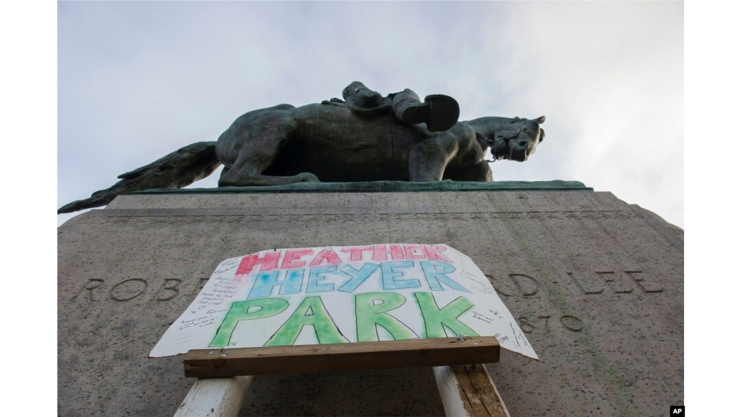 A sign saying Heather Heyer Park is placed at the base of the statue of Confederate Gen. Robert E. Lee in Emancipation Park in Charlottesville, Va., Aug. 18, 2017. Heyer was killed while protesting a white nationalist rally in Charlottesville Aug. 12.