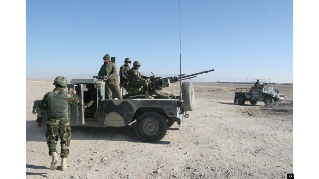 Afghan National Army soldiers guard at a checkpoint on the way to the Sangin district of Helmand province, Afghanistan, Wednesday, Dec. 23, 2015.