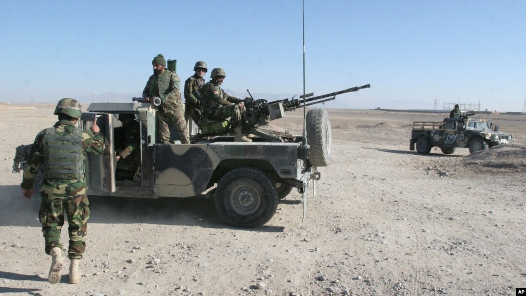 Afghan National Army soldiers guard at a checkpoint on the way to the Sangin district of Helmand province, Afghanistan, Wednesday, Dec. 23, 2015.
