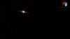 This image grab taken from a handout video released by the Syrian General Organization of Radio and Television late on Aug. 24, 2019 shows lights in the sky reportedly over Aqraba, southeast of the Syrian capital Damascus during an Israeli airstrike.