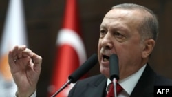 President of Turkey and leader of Justice and Development (AK) Party Recep Tayyip Erdogan speaks at the party's group meeting at Grand National Assembly of Turkey in Ankara, on February 12, 2020. (Photo by Adem ALTAN / AFP)
