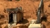 More than 100 mining companies have operations in an area near Meiganga, Cameroon. They use tractors and equipment that clean stones and sift soil, allowing them to detect gold faster than locals who use manual tools. (M. Kindzeka/VOA)