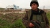 A Kurdish peshmerga fighter keeps watch in Zumar, Nineveh province, near Mount Sinjar, Dec. 18, 2014. 