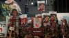 Relatives and supporters hold placards bearing portraits of Israeli hostages held in Gaza since the October 7 attacks by Hamas in southern Israel, during a rally calling for their release and marking their nearly 100 days of captivity, in Tel Aviv on Janu
