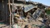 FILE- A teenage girl touched off explosives strapped to her body at a market in Maiduguri, Nigeria, leaving this debris, June 22, 2015