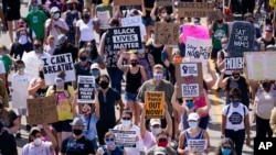 FILE - Hundreds march at a rally against racial inequality and police accountability, in Kenosha, Wisconsin, Aug. 29, 2020, following the police shooting of Jacob Blake.