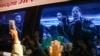 Hostages released by Hamas wave to the crowd from a vehicle driving towards an army base in Ofakim on November 26, 2023 after they were released by Hamas from the Gaza Strip.