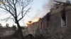 A firefighter works to douse a fire in a building, as Russia's attack on Ukraine continues, in Mykolaiv