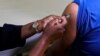 FILE - A healthcare worker administers the Pfizer coronavirus disease (COVID-19) vaccine to a man, amidst the spread of the SARS-CoV-2 variant Omicron, in Johannesburg, South Africa, Dec. 9, 2021.
