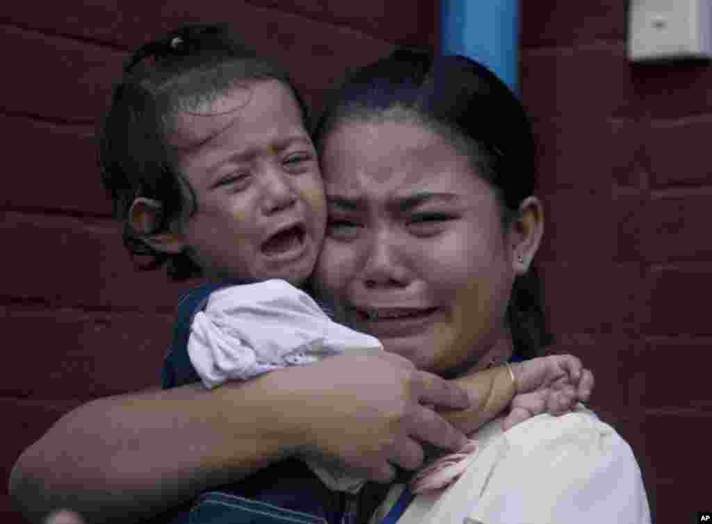 Chit Su Win, wife of detained Reuters journalist Kyaw Soe Oo, cries with her daughter outside the court in Yangon, Myanmar.