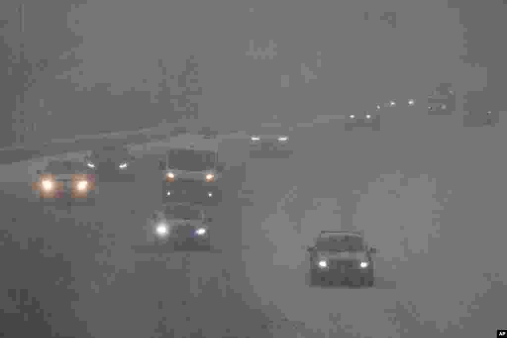 Vehicles drive along a highway during a winter storm, Jan. 5, 2025, in Cincinnati, Ohio.