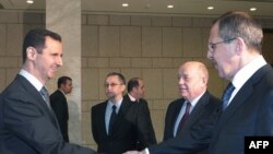 Президент Сирії Башар аль-Асад вітає в Дамаску міністра закордонних справ Росії Сергія Лаврова