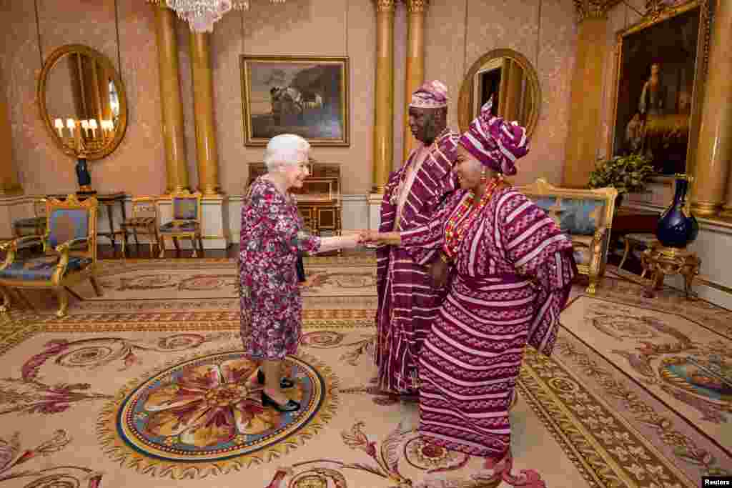 Britain&#39;s Queen Elizabeth meets George Adesola Oguntade, the High Commissioner of the Federal Republic of Nigeria, as he presents his Letter of Credence, with his wife, Mrs Oguntade, during a private audience at Buckingham Palace in central London.