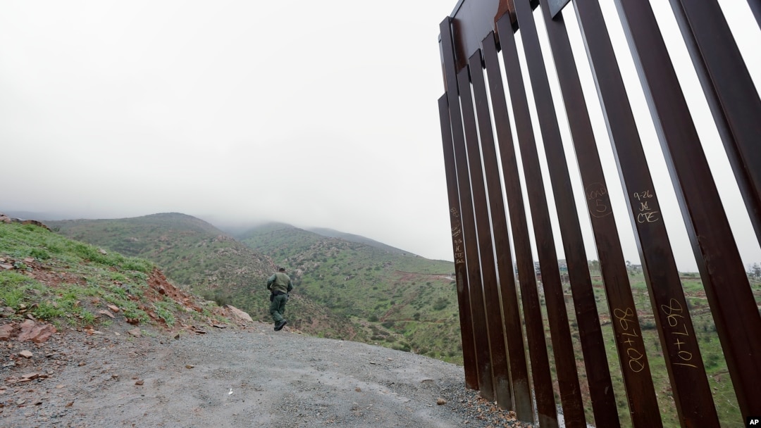 Border Patrol agent Vincent Pirro looks on near where a border wall ends that separates the cities of Tijuana, Mexico, and San Diego, California, Feb. 5, 2019, in San Diego. 