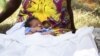 Woman in African dress with baby
