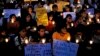 Activists from Bengaluru Solidarity Group, a social group, hold candles and placards during a vigil to commemorate the 30th anniversary of Bhopal gas tragedy, in the southern Indian city of Bengaluru, previously known as Bangalore, December 2, 2014.