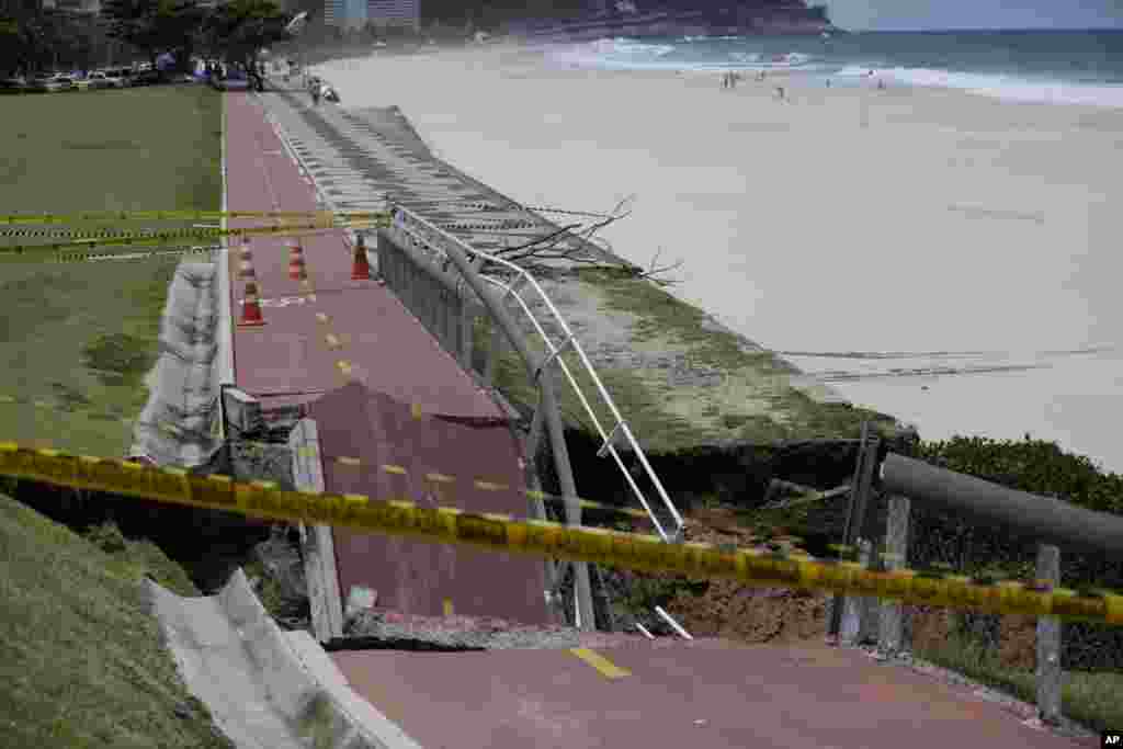 A bike path is seen partially collapsed after heavy rains in Rio de Janeiro, Brazil. Overnight storms flooded roads, downed trees and left four dead.