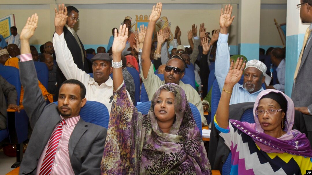 FILE - Somalia lawmakers raise their hands during a confidence vote on Prime Minister Abdiweli Sheikh Ahmed, at the Parliament Building in Mogadishu, Somalia.