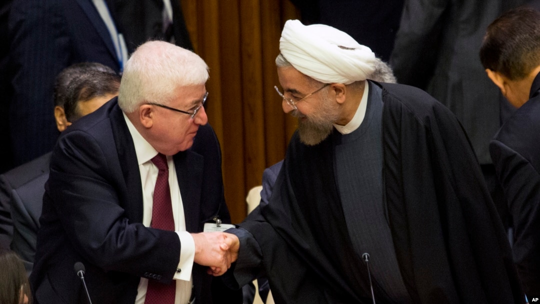 FILE - Iraq's President Fuad Masum, left, is greeted by Iranian President Hassan Rouhani as he arrives at the Climate Summit 2014 at U.N. headquarters, Sept. 23, 2014. 