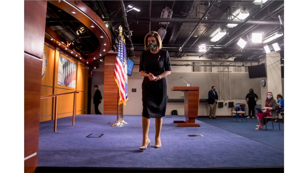 FILE - House Speaker Nancy Pelosi of Calif., wears a mask as she steps away from the podium at the conclusion of a news conference on Capitol Hill, May 14, 2020, in Washington.