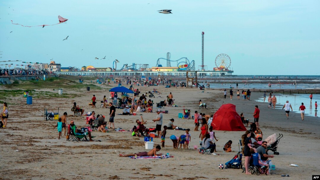 Beachgoers enjoy a day of sunshine at Galveston Beach on May 2, 2020 in Galveston, Texas, amid the coronavirus pandemic. - Texas beaches were ordered to be opened on May 1, 2020. In a statement, the City of Galveston said, "The City of Galveston's…