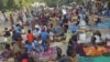 Cameroonian refugees who fled the violence that broke out in the border village of Ouloumsa in a dispute between herders, fishermen and farmers over dwindling water resources gather in N'Djamena, Chad, Dec. 10, 2021.