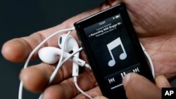 A photo illustration shows a digital music player held in London. 