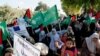 FILE - Hamas supporters protest against Israel's plan to annex parts of the West Bank and US President Donald Trump's Mideast initiative, at the Palestinian side of Erez checkpoint between Israel and Gaza, in Beit Hanoun, Gaza Strip, July 9, 2020.