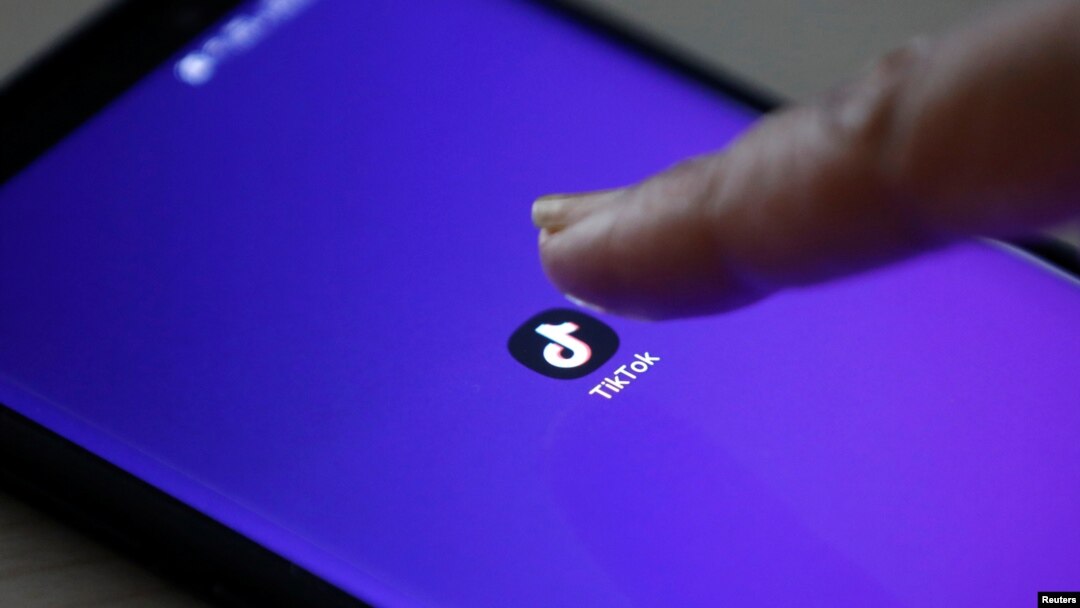 The logo of the TikTok application is seen on a mobile phone screen.