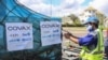 FILE - A worker handles boxes of COVID-19 vaccines, delivered as part of the COVAX equitable vaccince distribution program, at Ivato International Airport, in Antananarivo, Madagascar, May 8, 2021. 