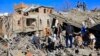 Yemenis inspect the damage following overnight air strikes by the Saudi-led coalition targeting the Huthi rebel-held capital Sanaa, Jan. 18, 2022. 