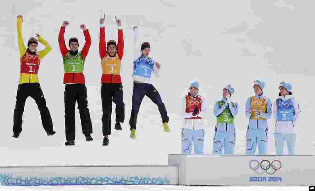 Germany&#39;s team Eric Frenzel, Bjoern Kircheisen, Johannes Rydzek and Fabian Riessle, from left, celebrate winning the silver as Norway&#39;s gold medal winners Magnus Hovdal Moan, Haavard Klemetsen, Magnus Krog and Joergen Graabak, from left, applaud during the flower ceremony of the Nordic Combined Gundersen large hill team comptetition, Sochi, Feb. 20, 2014. during the flower ceremony of the Nordic combined Gundersen large hill team competition at the 2014 Winter Olympics, Thursday, Feb. 20, 2014