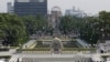 FILE - In this Aug. 6, 2013 file photo, doves fly over the cenotaph dedicated to the victims of the atomic bombing at the Hiroshima Peace Memorial Park during a ceremony marking the 68th anniversary of the bombing, in Hiroshima, western Japan.