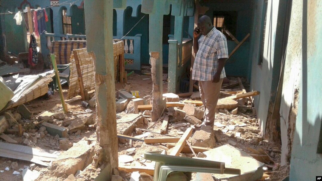 A man stands amid the debris at the scene of an attack in the town of Mandera, Kenya, near the border with Somalia, Oct. 25, 2016. 