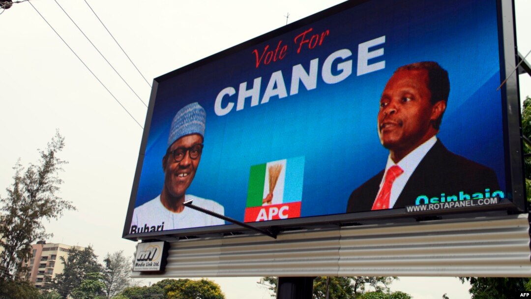 FILE - An electronic billboard displays a campaign poster of All Progressives Congress presidential candidate Mohammadu Buhari and running mate Yemi Osinbajo, who this week won Nigeria's democratic election.