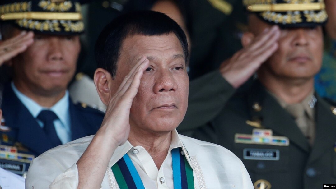 FILE - Philippine President Rodrigo Duterte salutes with other military officers during a anniversary celebration of the Armed Forces at a military camp in Quezon city, Manila.