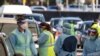 Medical workers administer tests at the Bondi Beach drive-thru coronavirus disease (COVID-19) testing center in the wake of new positive cases in Sydney, Australia, June 17, 2021. 