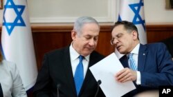 Israeli Prime Minister Benjamin Netanyahu, left, and Cabinet Secretary Tzahi Braverman attend the weekly Cabinet meeting at his office in Jerusalem, Dec. 1, 2019. 