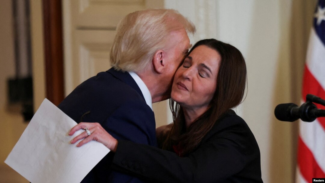 U.S. President Donald Trump greets Laken Riley's mother, Allyson Phillips, during an event to sign the Laken Riley Act at the White House in Washington on Jan. 29, 2025.