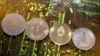 FILE - Representations of the Ripple, Bitcoin, Etherum and Litecoin virtual currencies, Feb. 13, 2018. 