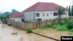 Newly-built houses on the bank of the River Kaduna are seen in flood waters after hours of rainfall in Kaduna, Nigeria August 15, 2015.