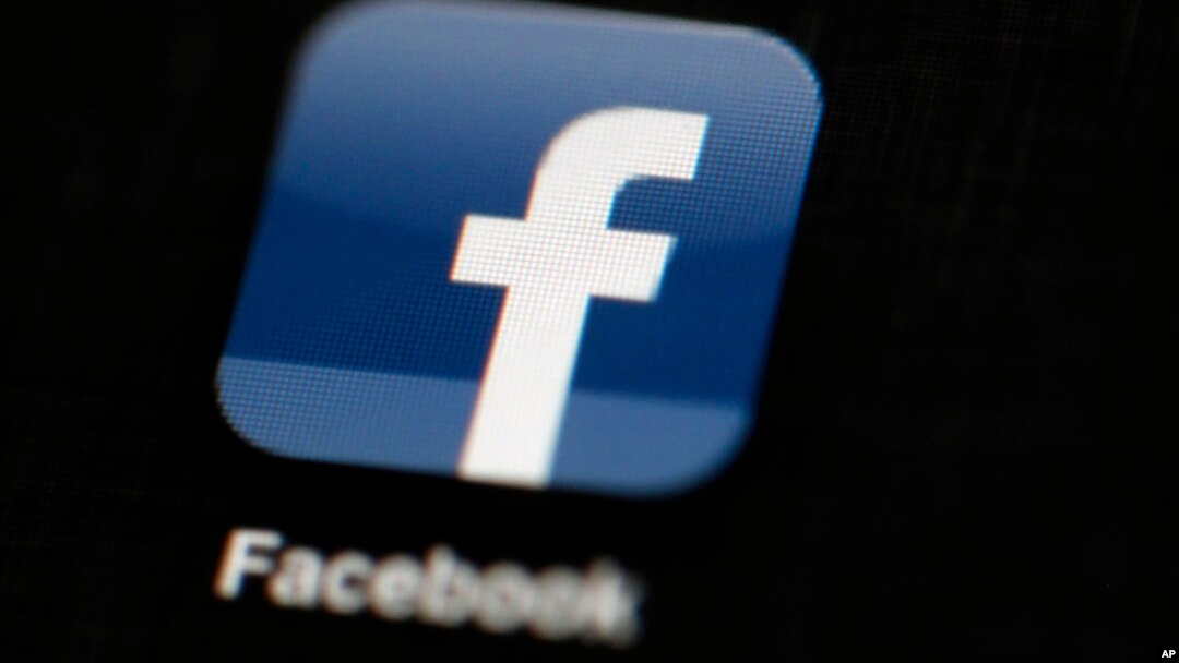 FILE - The Facebook logo is displayed on an iPad.