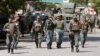 Afghan policemen arrive at the site of an attack and gun fire in Kabul, May 9, 2018. 