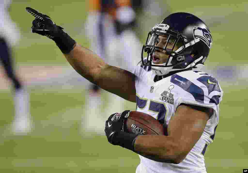 Seattle Seahawks outside linebacker Malcolm Smith (53) reacts after running back an interception for a touchdown against the Denver Broncos during the first half of the NFL Super Bowl XLVIII football game, Feb. 2, 2014.