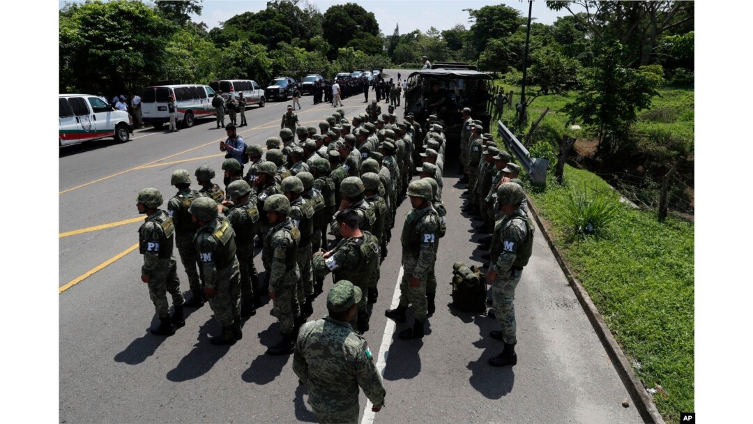 Military police form on the highway, in Metapa, Chiapas state, Mexico, June 5, 2019. A law enforcement group of police officers, marines, military police and immigration officials arrived at the area to intercept a caravan of migrants that had earlier crossed the Mexico-Guatemala border.