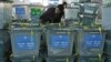 An Afghan elections worker notes the serial numbers of ballot boxes at a warehouse Independent Elections Commission in Kabul, April 6, 2014.