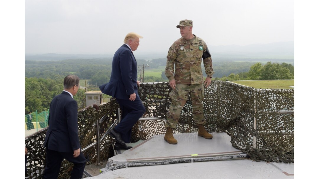 President Donald Trump and South Korean President Moon Jae-in, left, walk up to view North Korea from the Korean Demilitarized Zone from Observation Post Ouellette at Camp Bonifas in South Korea, Sunday, June 30, 2019.